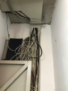 Trục kỹ thuật tòa nhà với dây mạng, dây camera chưa gom gọn – hiện trạng khi khảo sát bảo trì